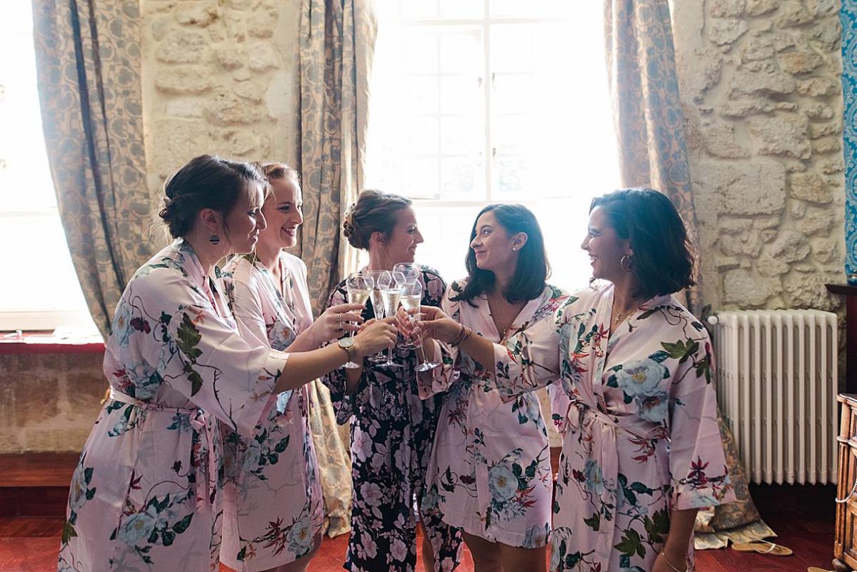 photographe de mariage en gironde pour les préparatifs de la mariée avec une coupe de champagne avec les demoiselles d'honneur au chateau de la ligne à Lignan de Bordeaux par pixaile photography