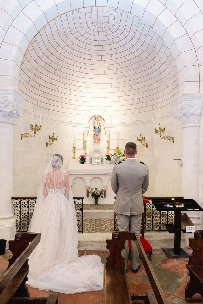les mariés prient pour la vierge marie à l'église
