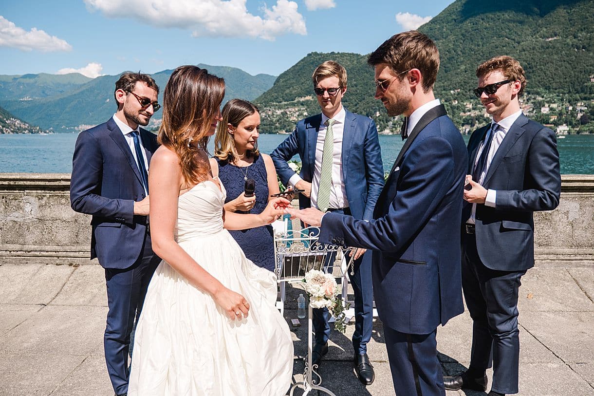 la mariée met la bague de mariage au marié lors de la cérémonie laique à la villa pizzo au lac de come